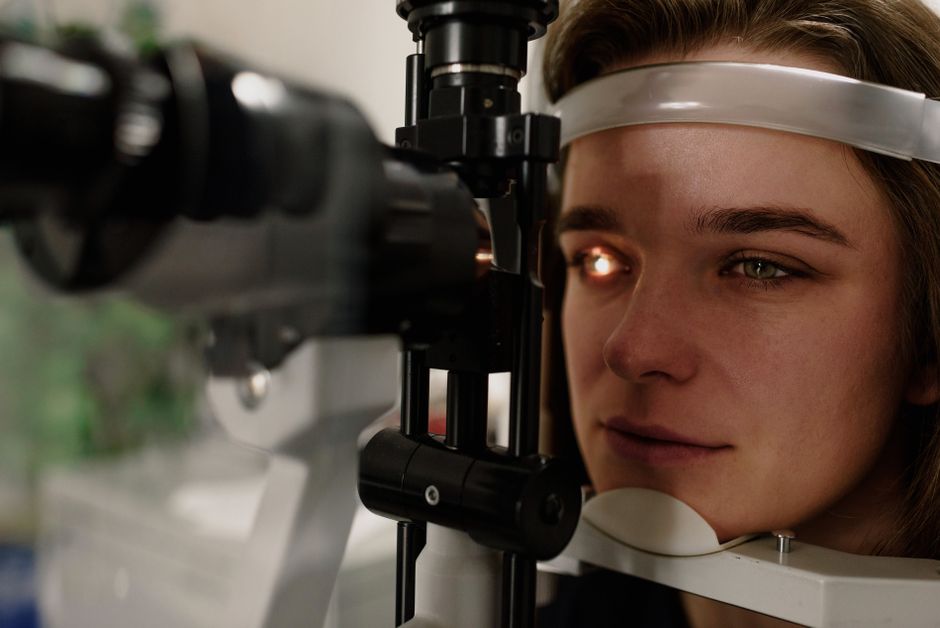 Optometrist performing an eye test with a phoropter.